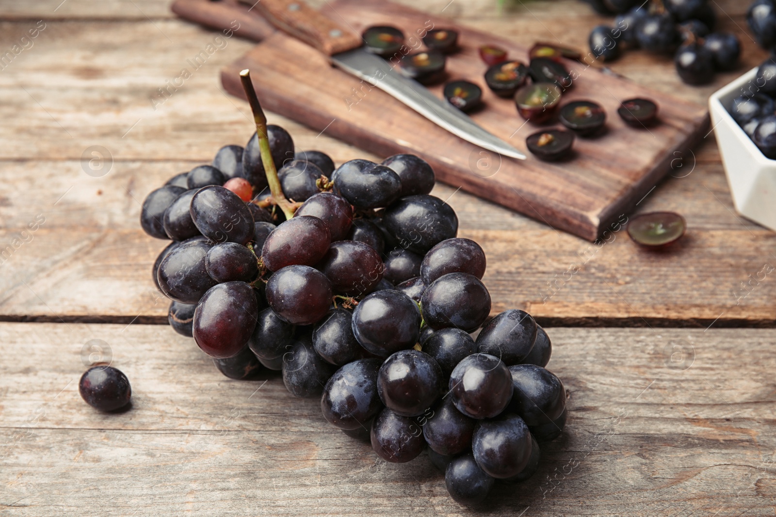 Photo of Fresh ripe juicy grapes on wooden table