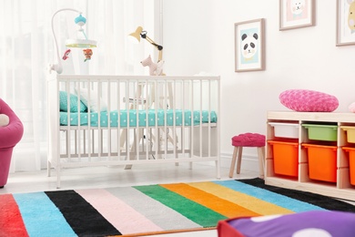 Photo of Colorful baby room interior with comfortable crib