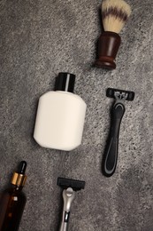 Flat lay composition with shaving accessories for men on grey table