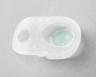 Photo of Package with contact lens on light background