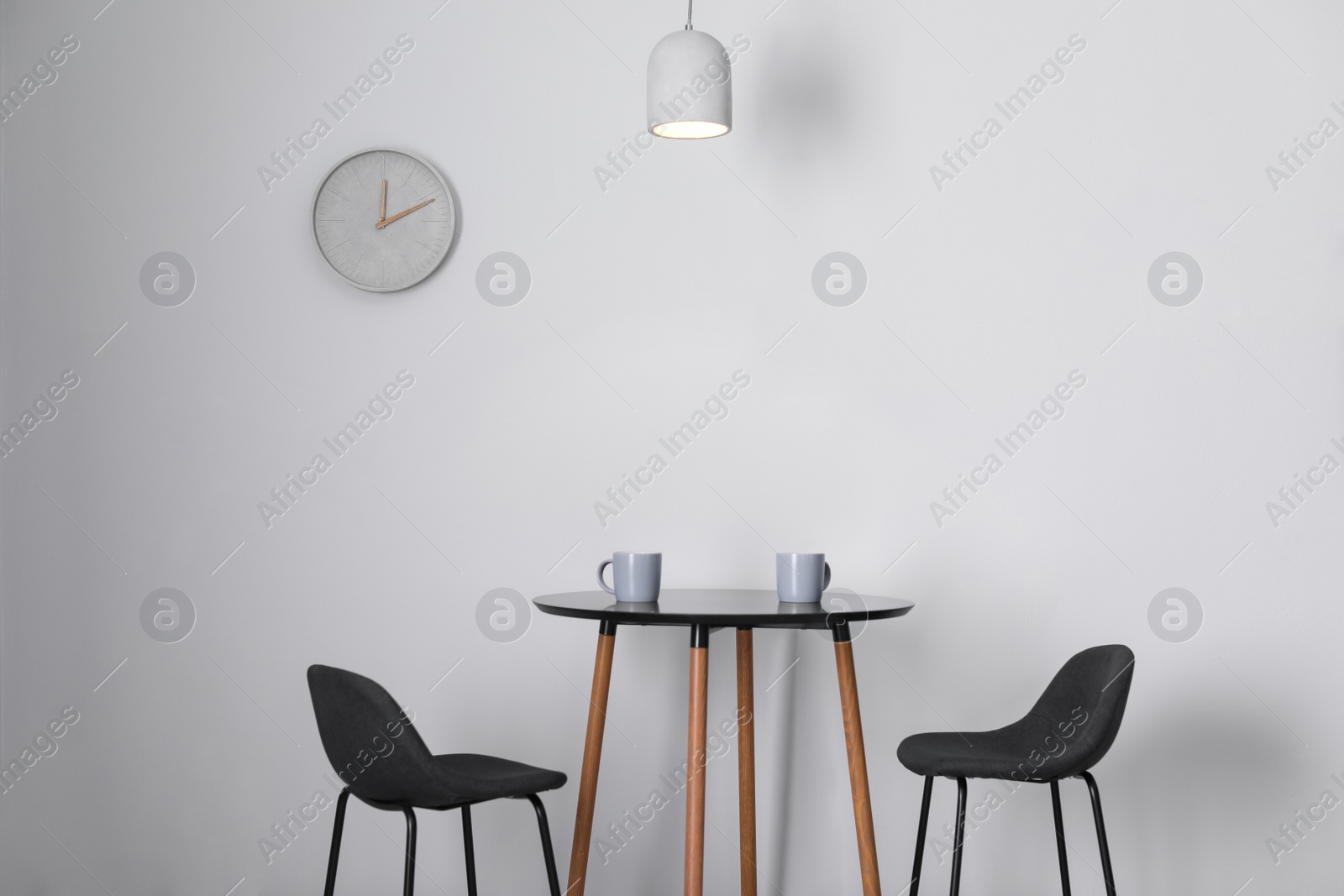 Photo of Stylish room interior with wall clock. Time of day