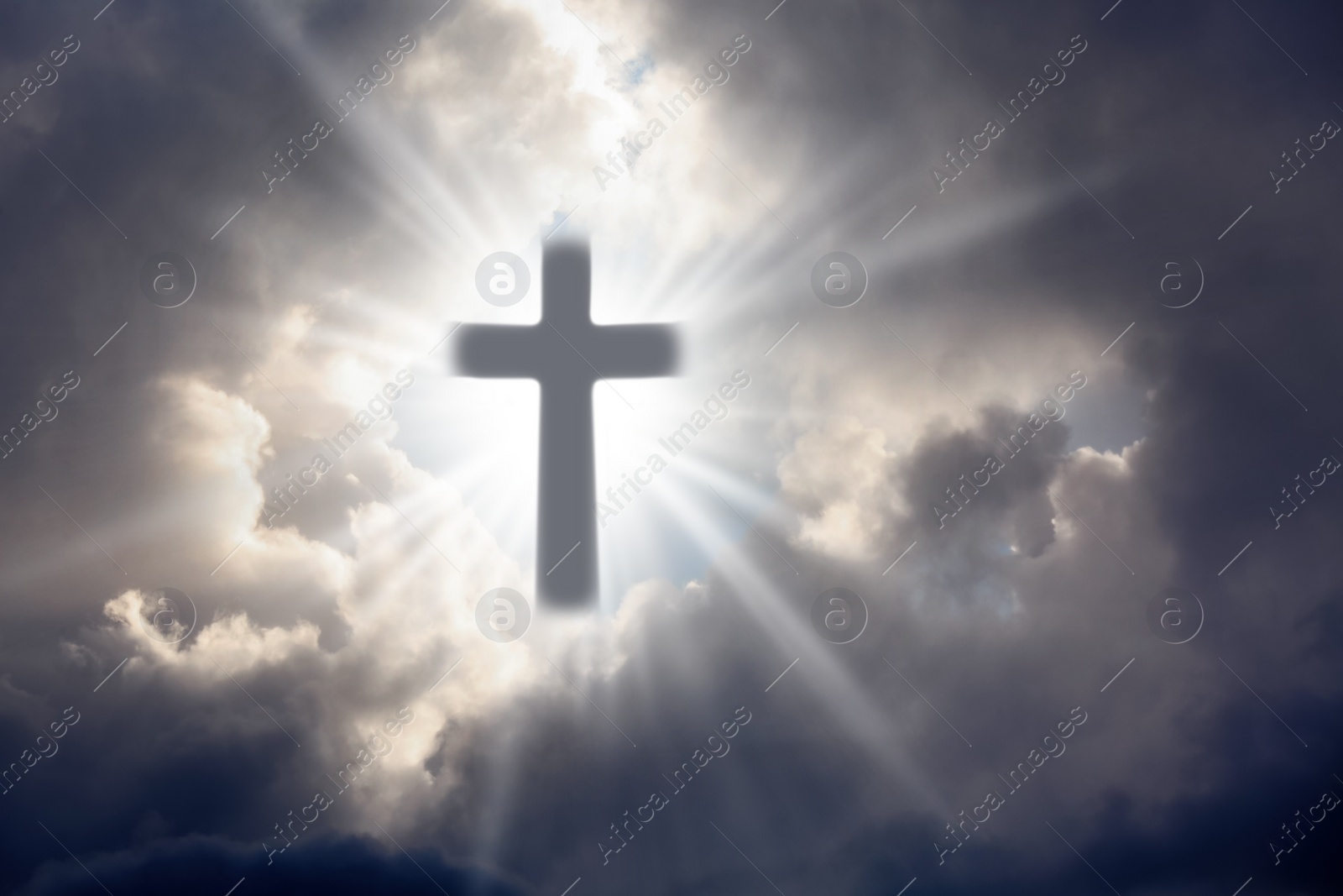 Image of Silhouette of cross against cloudy sky. Christian religion