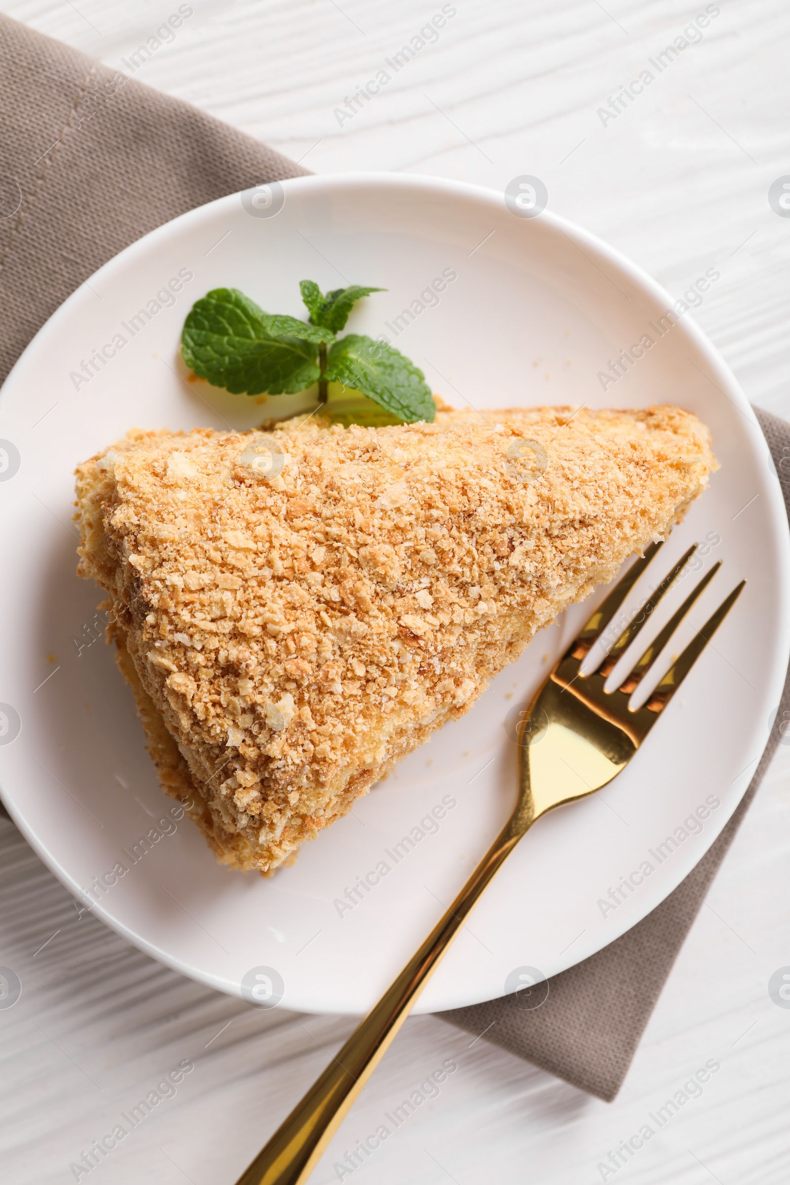 Photo of Piece of delicious Napoleon cake served on table, top view