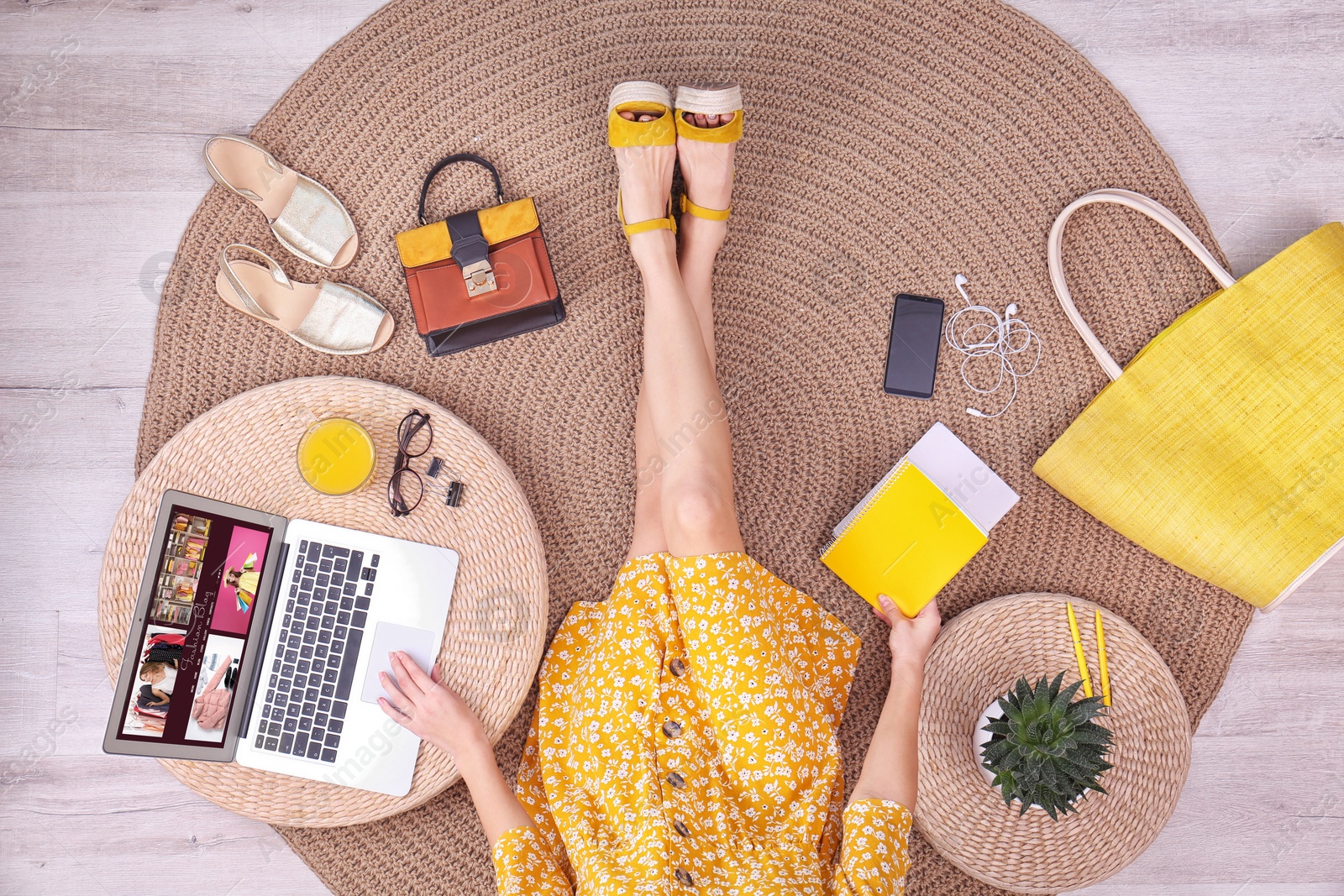 Photo of Fashion blogger with laptop sitting on floor, top view