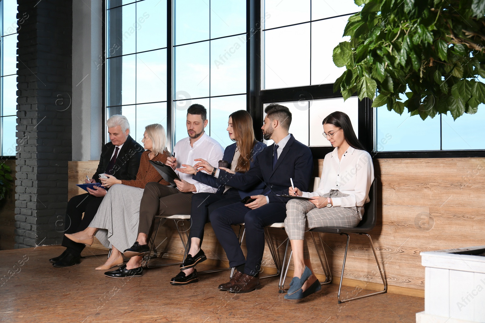 Photo of People waiting for job interview in office hall