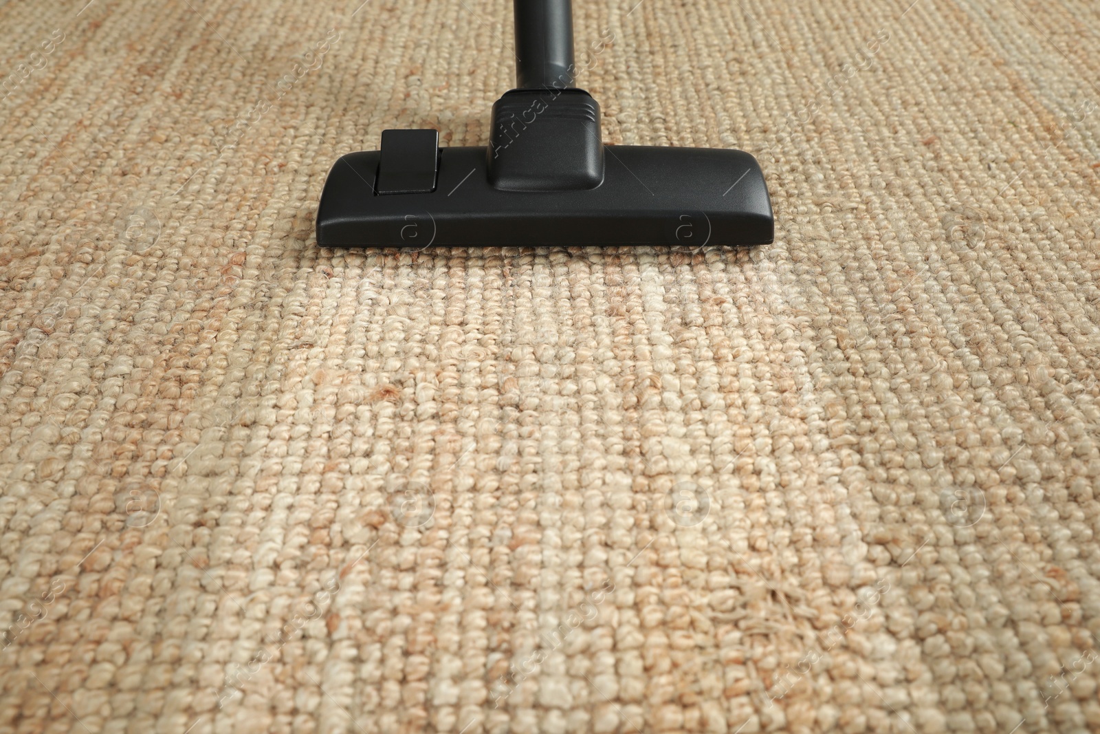 Image of Hoovering carpet with vacuum cleaner, closeup and space for text. Clean trace on dirty surface