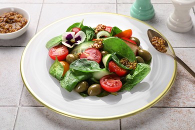 Photo of Delicious salad with vegetables, olives and grain mustard on light table, closeup