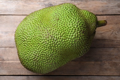 Photo of Fresh exotic jackfruit on wooden table, top view