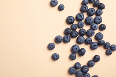 Photo of Flat lay composition with tasty blueberry and space for text on color background