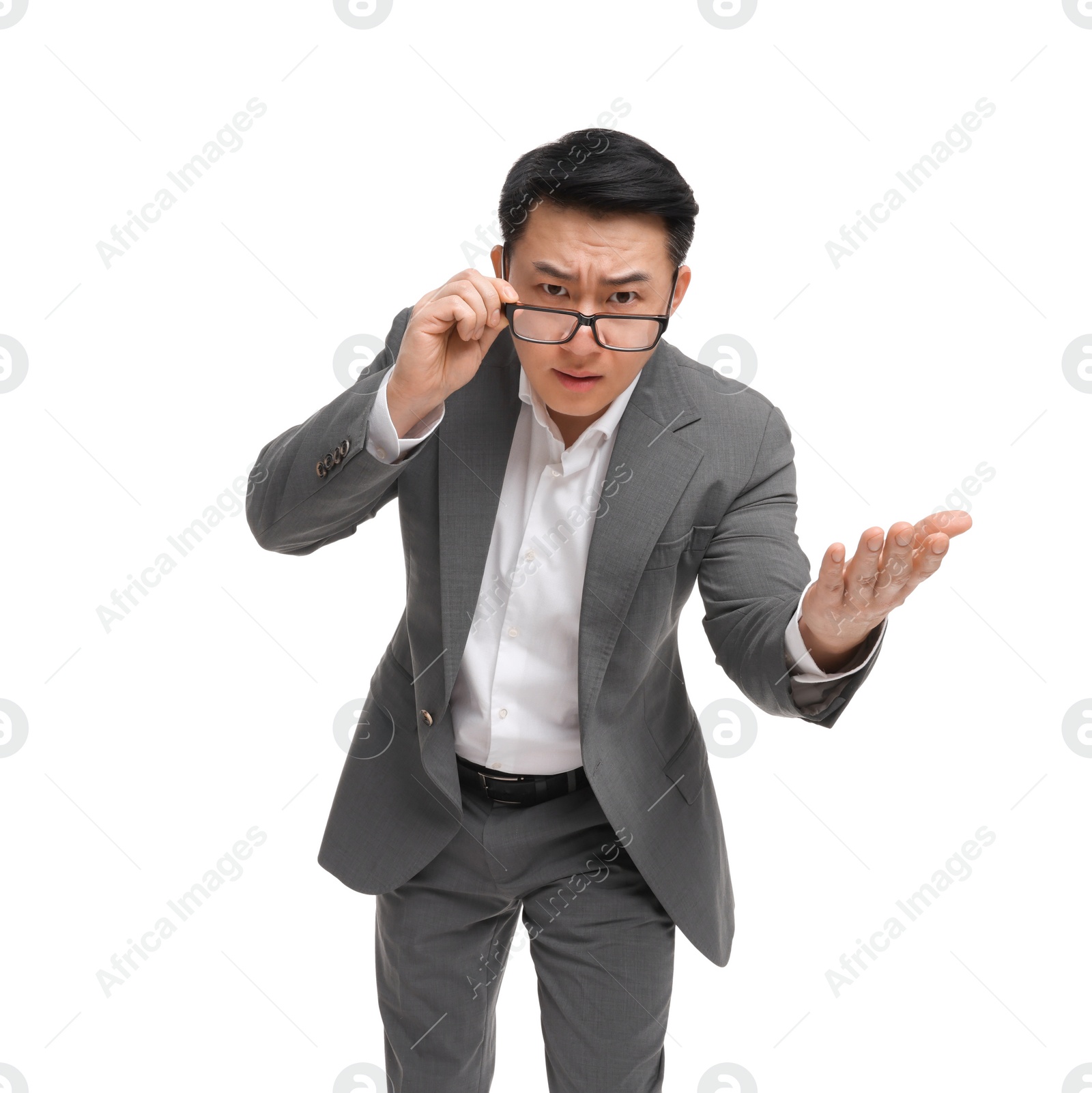 Photo of Angry businessman in suit wearing glasses on white background, low angle view