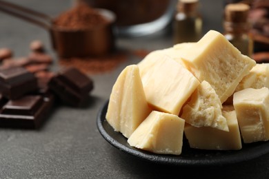 Photo of Organic cocoa butter on grey table, closeup