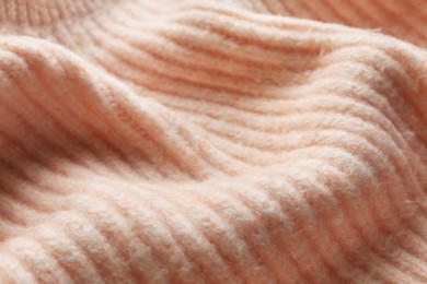 Photo of Beautiful pale pink knitted fabric as background, closeup