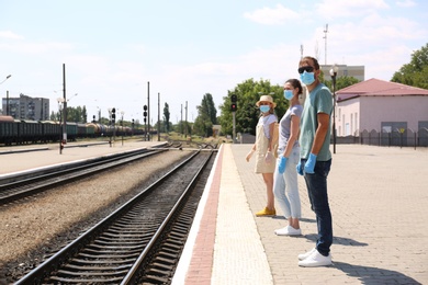 Photo of People keeping social distance in line at train station. Coronavirus pandemic