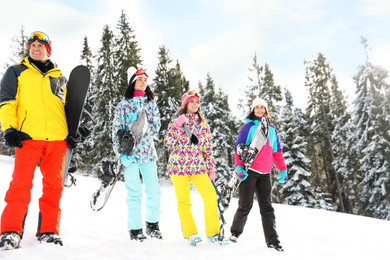 Group of friends with equipment in snowy mountains. Winter vacation