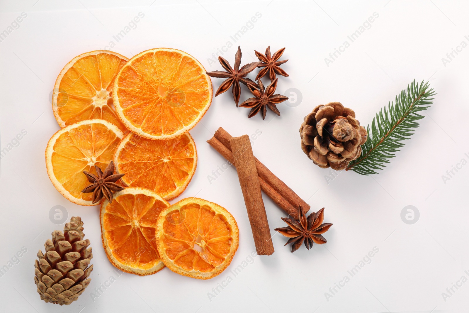 Photo of Flat lay composition with dry orange slices, anise stars and cinnamon sticks on white background