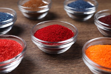 Photo of Many different food coloring on wooden table, closeup