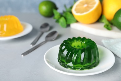 Photo of Delicious fresh green jelly on grey table, space for text