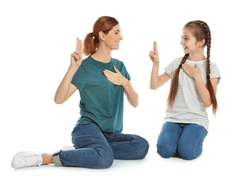 Photo of Hearing impaired mother and her child talking with help of sign language on white background