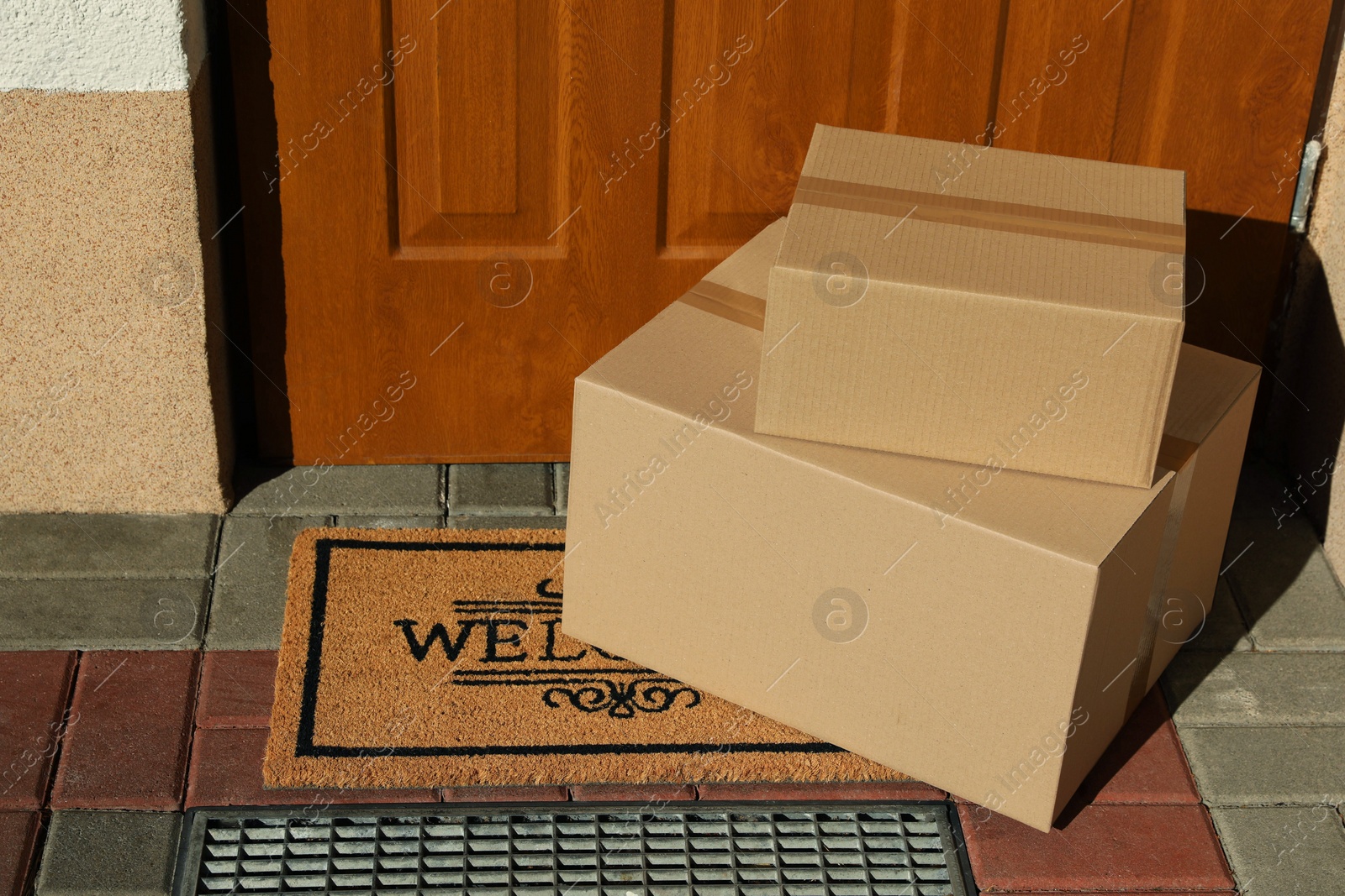 Photo of Parcels delivered on mat near front door