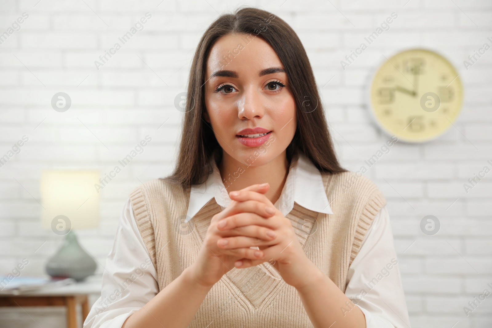 Photo of Portrait of young businesswoman in light room