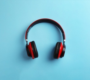 Photo of Wireless headphones on color background, top view