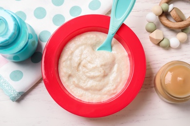 Flat lay composition with healthy baby food on white wooden table