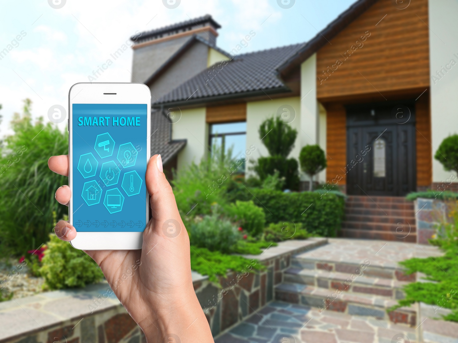 Image of Woman using home security app on smartphone outdoors, closeup. Space for text