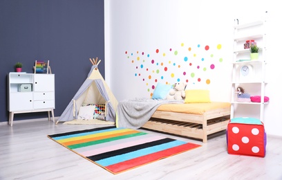 Modern child room interior with bed and play tent