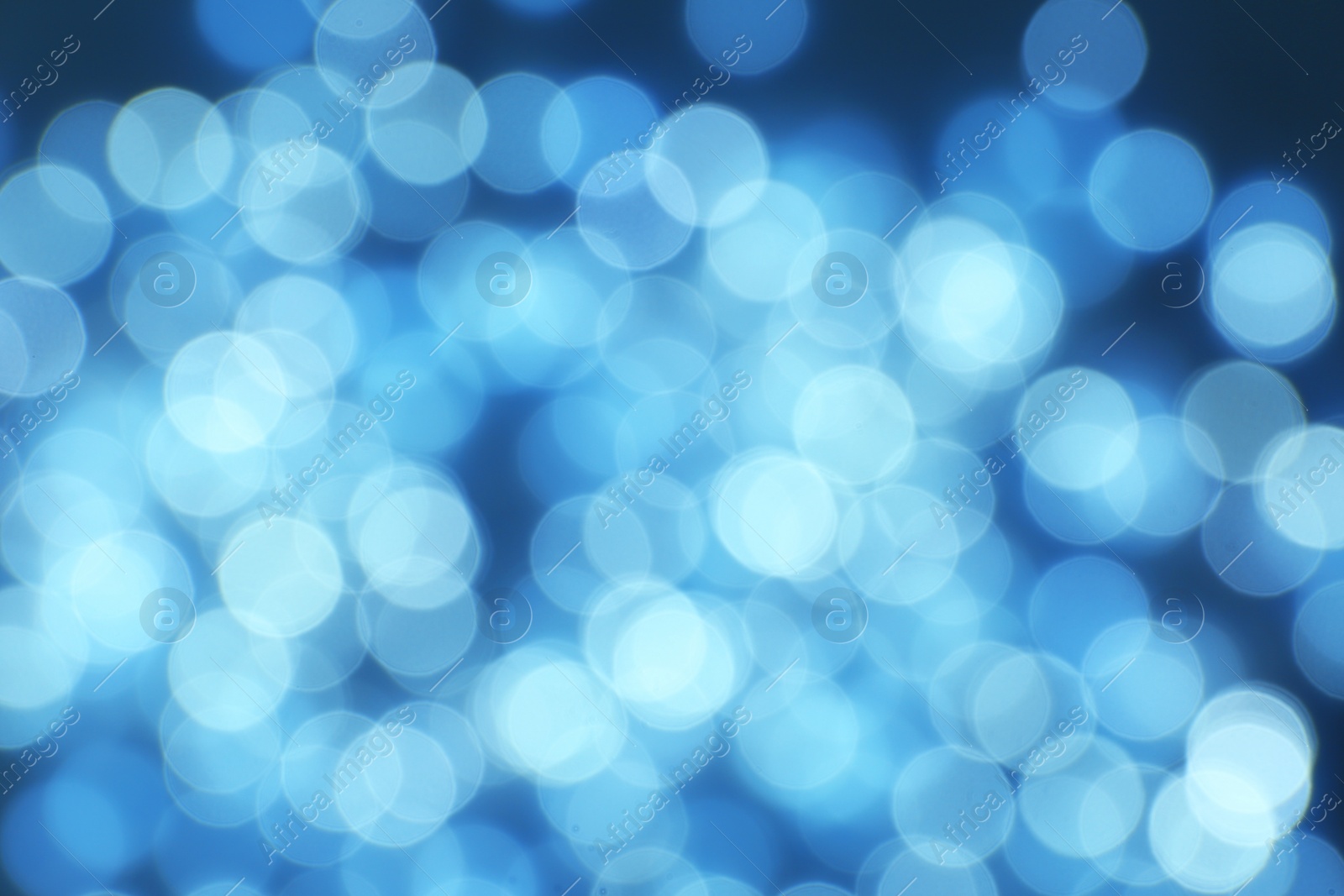 Photo of Blurred view of Christmas lights on dark background