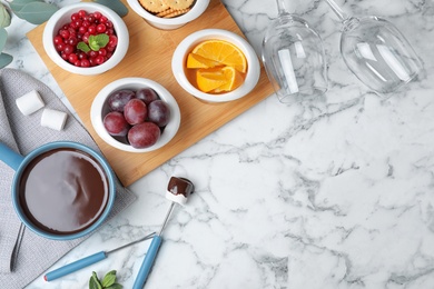 Photo of Flat lay composition with chocolate fondue and space for text on white marble background