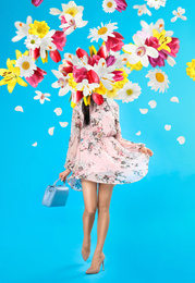 Creative spring fashion composition. Walking girl and flowers splash