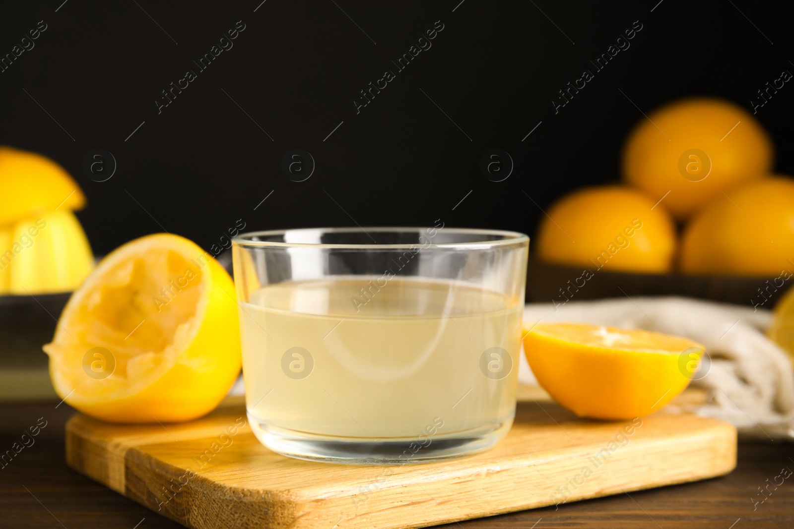 Photo of Freshly squeezed lemon juice in glass bowl on table