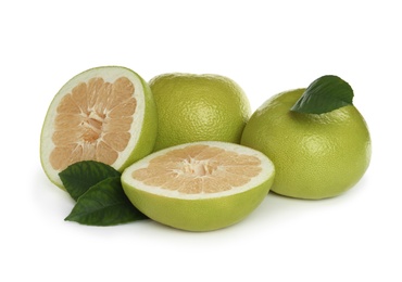 Whole and cut sweetie fruits with green leaves on white background