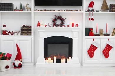 Cosy room with fireplace and burning candles. Christmas atmosphere