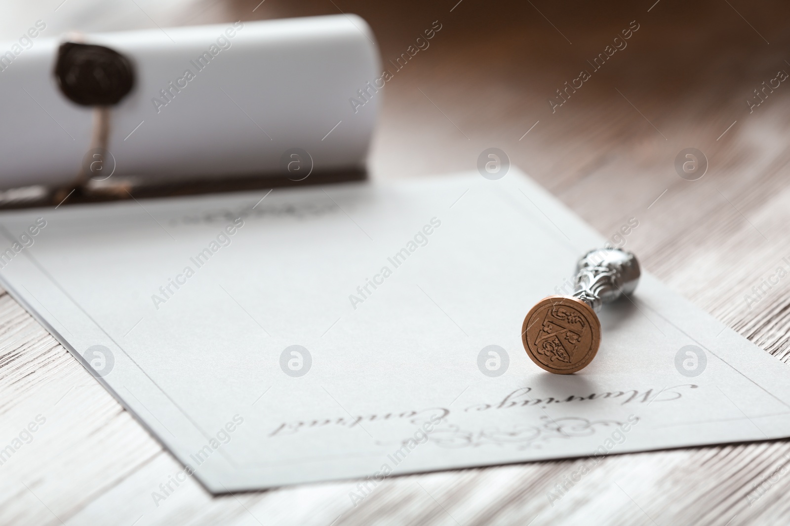Photo of Vintage notary stamp and document on wooden table, closeup. Space for text