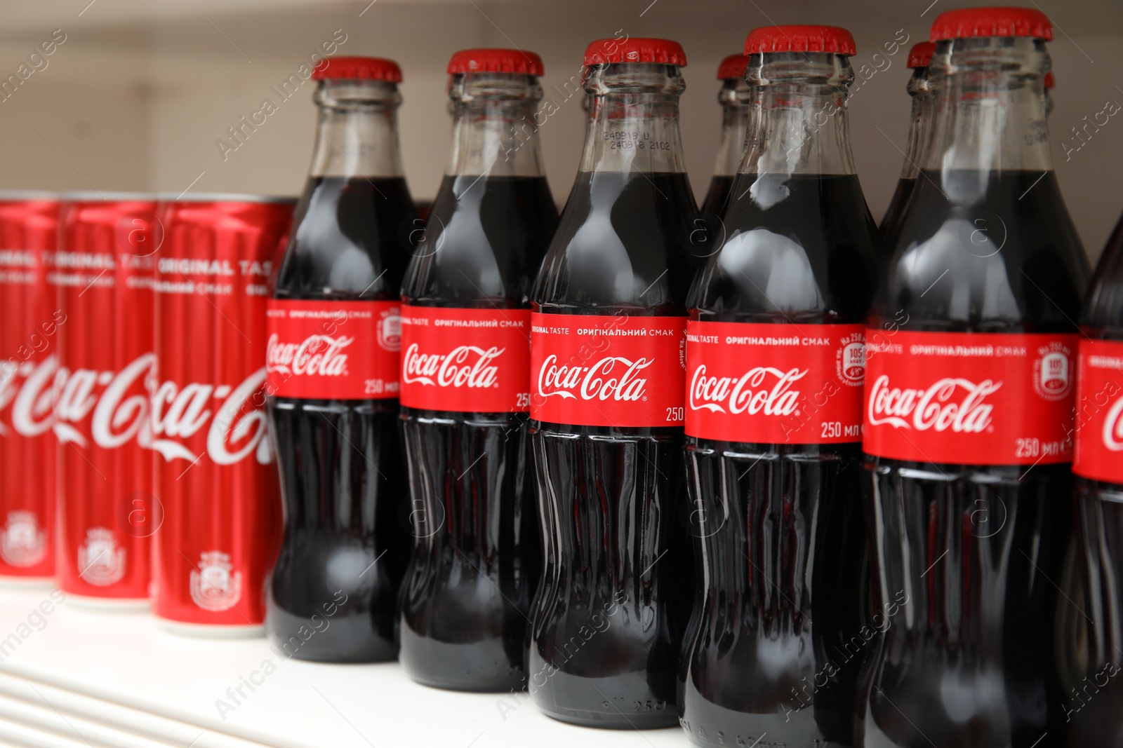 Photo of MYKOLAIV, UKRAINE - NOVEMBER 14, 2018: Coca-Cola cans and bottles on display in store