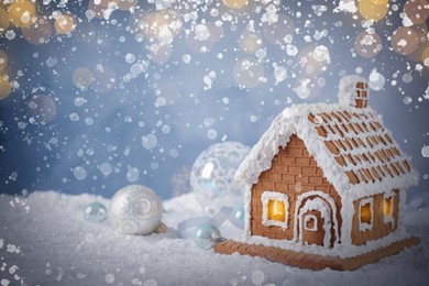 Image of Beautiful gingerbread house decorated with icing on snow, space for text