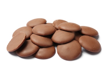 Photo of Delicious milk chocolate chips on white background