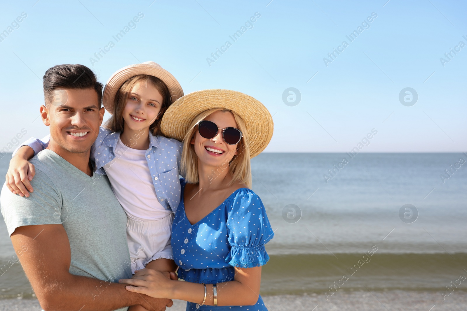 Photo of Happy family at beach on sunny summer day