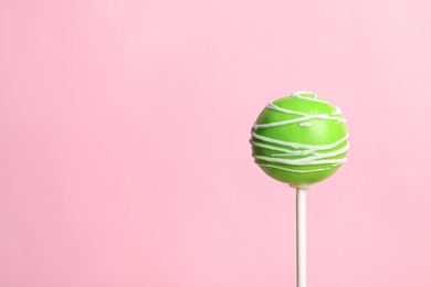 Photo of Bright delicious cake pop on color background. Space for text