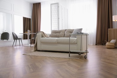 Modern living room with parquet floor and stylish furniture
