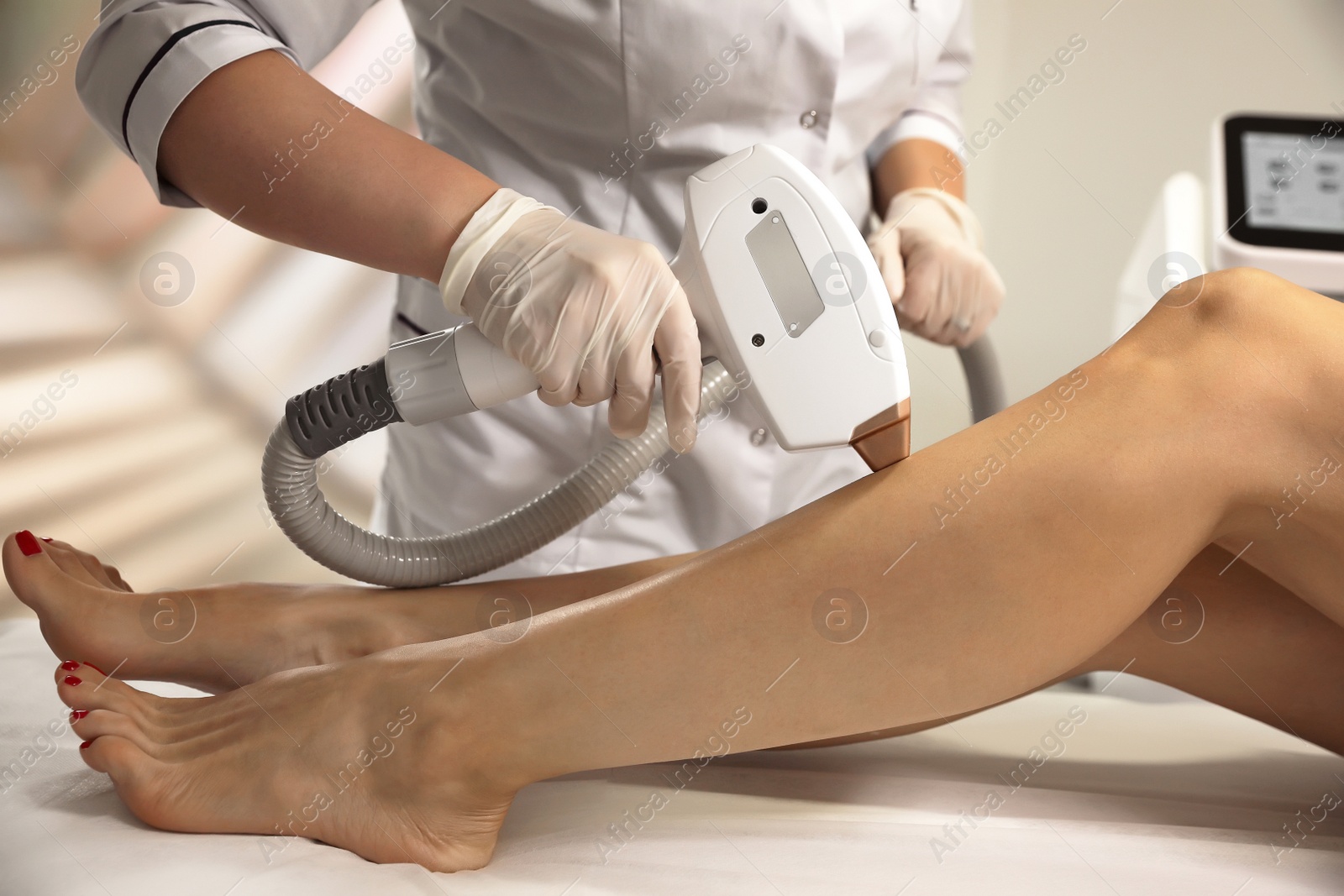 Photo of Woman undergoing laser epilation procedure in beauty salon, closeup