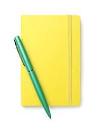 Photo of Closed yellow notebook with pen isolated on white, top view