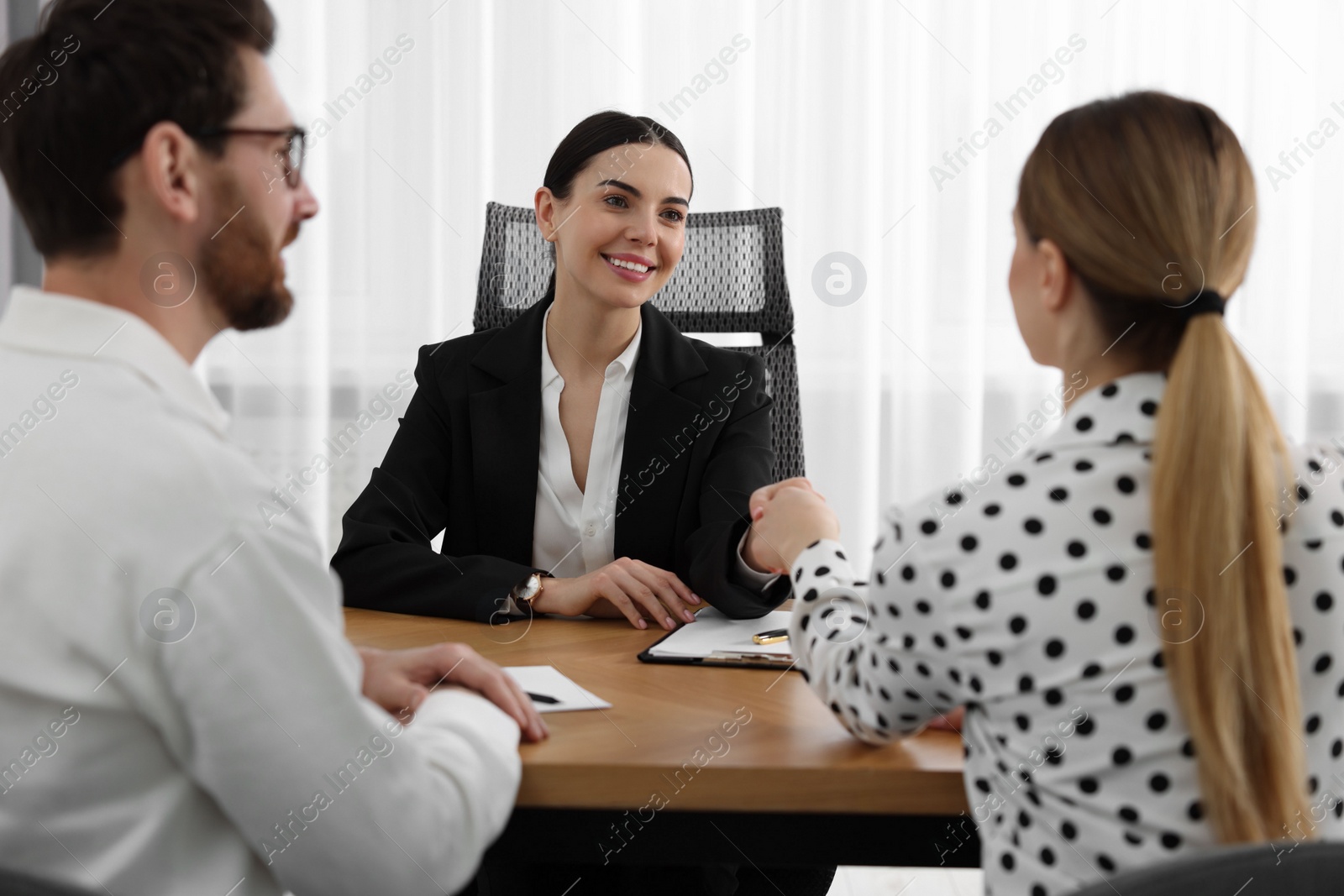 Photo of Lawyer shaking hands with clients in office