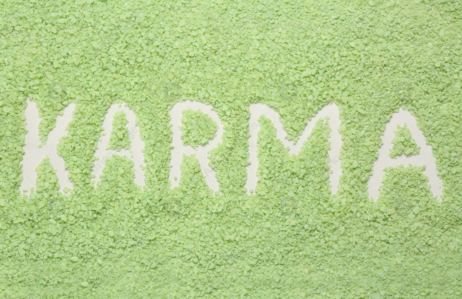 Photo of Word Karma made of sea salt as background, top view