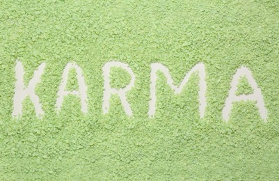 Photo of Word Karma made of sea salt as background, top view