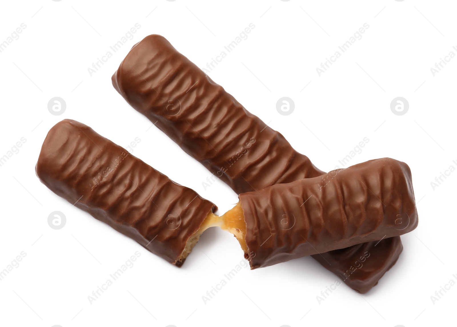 Photo of Sweet tasty chocolate bars with caramel on white background, top view