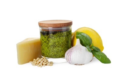 Tasty pesto sauce in glass jar and ingredients on white background