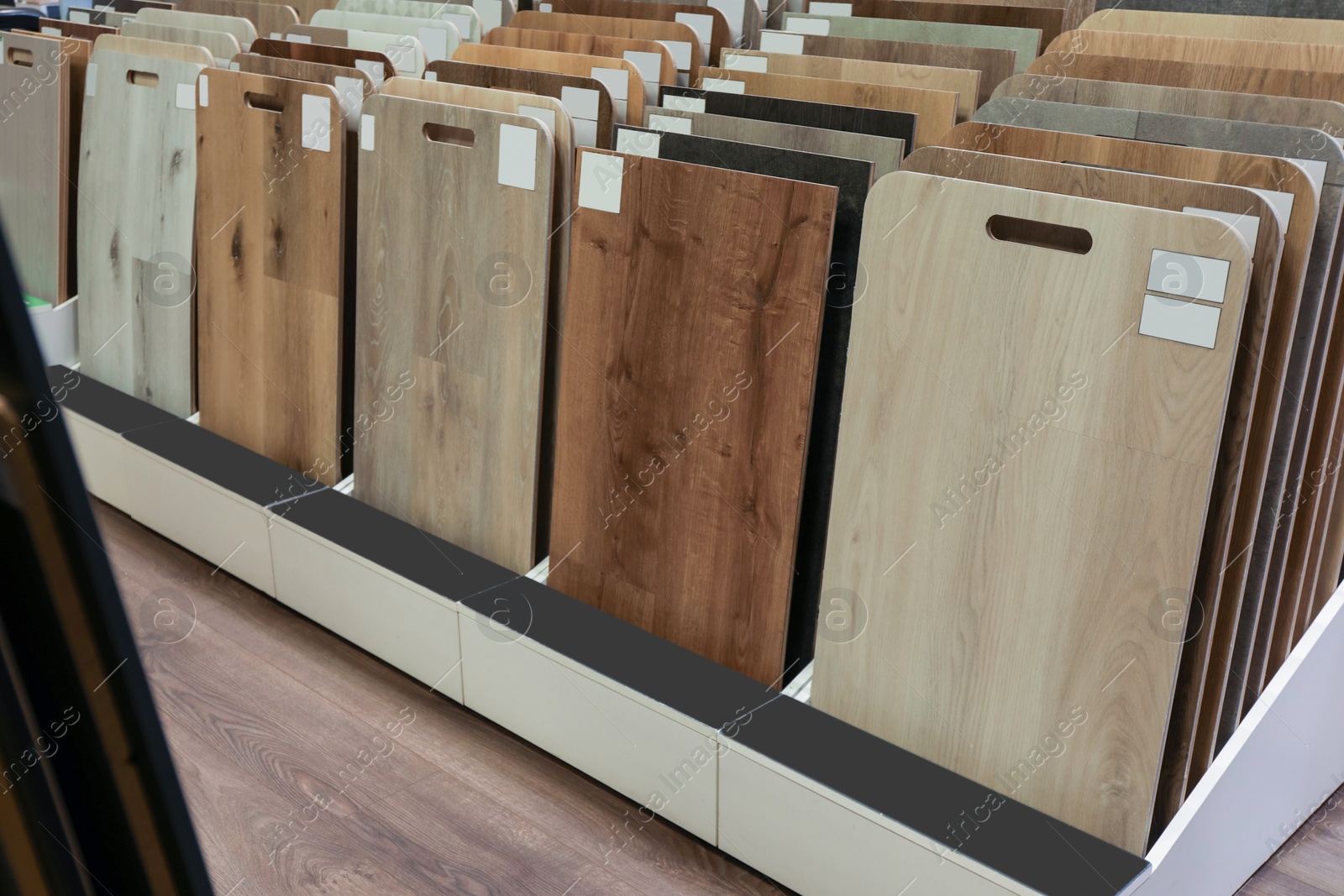 Photo of Many different samples of wooden flooring in store