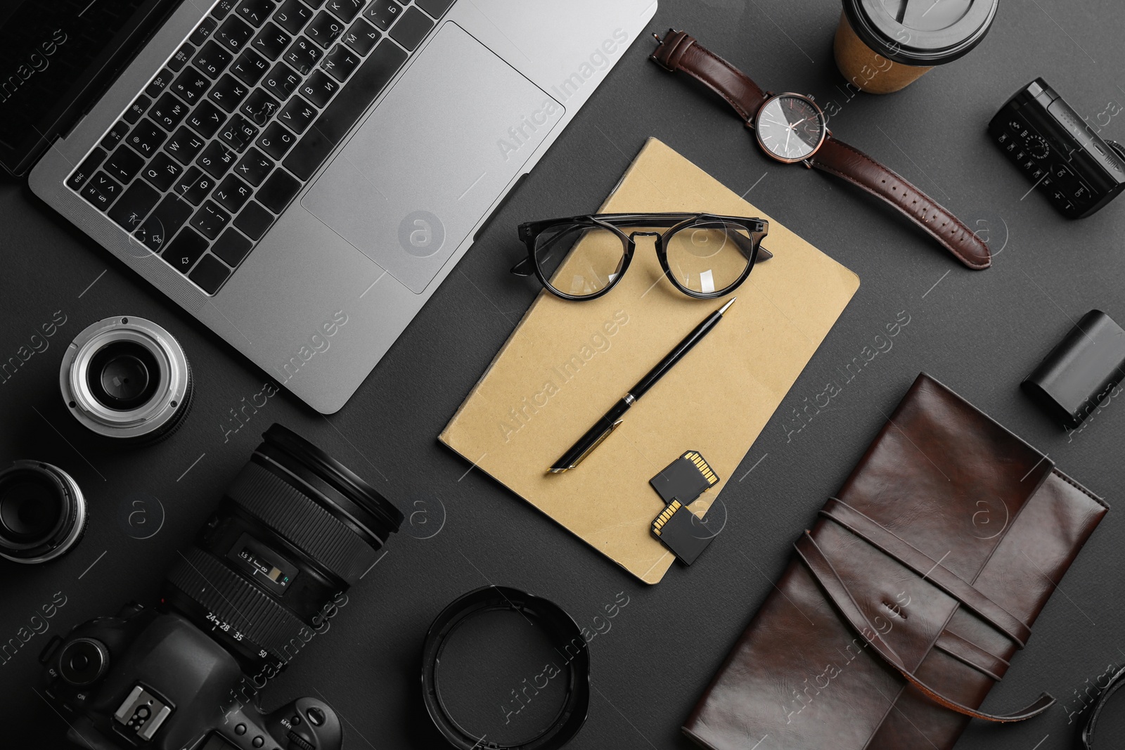 Photo of Flat lay composition with professional photographer equipment on dark background